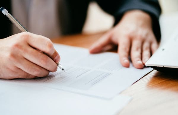 Personne signant des documents liés à la Sécurité Sociale pour expatriation avec Grospiron