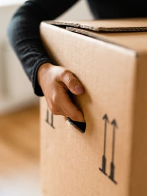 Carton de déménagement en main, image des services internationaux de Grospiron
